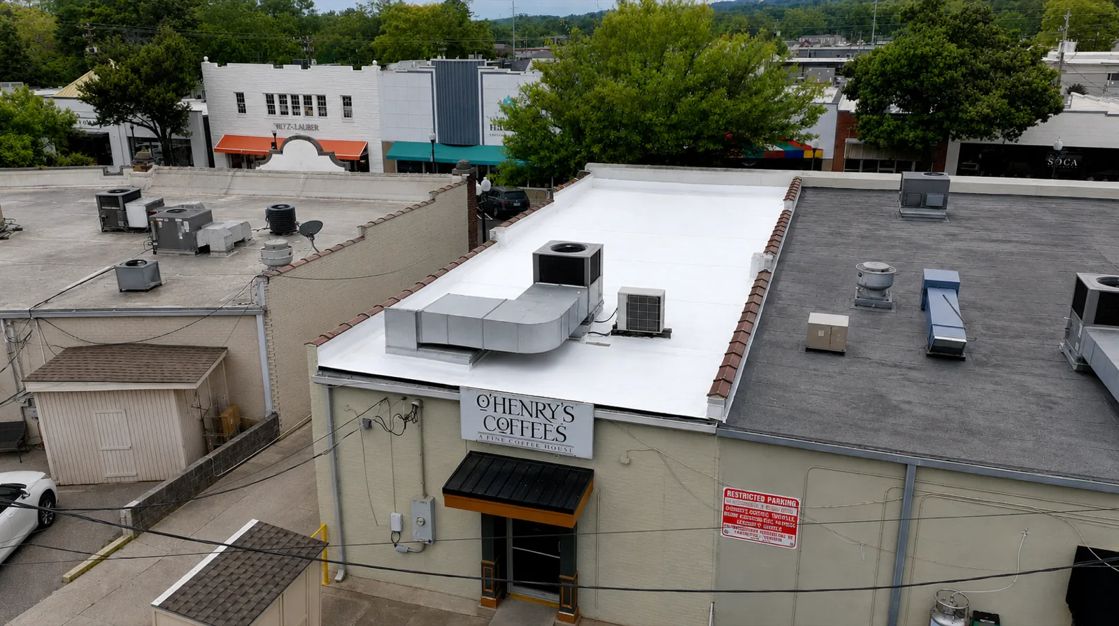 White flat membrane roof with rooftop HVAC units above O'Henry's Coffees, Homewood AL